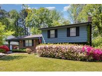 Charming two-story home with lush landscaping, brick accents and inviting curb appeal at 1636 Cone Ave, Apex, NC 27502