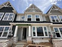 Charming new construction home with stone accents, gray siding, and a welcoming front entrance at 3022 White Rail Dr, Fuquay Varina, NC 27526