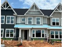 A modern two-story townhouse under construction with gray siding, black roof, and white trim, showcasing contemporary design at 3022 White Rail Dr, Fuquay Varina, NC 27526