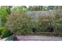 Charming exterior view with flowering trees and wood fence at 304 Cedarwood Ln, Carrboro, NC 27510