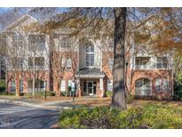 Brick condo building featuring balconies, multiple windows, and well-maintained landscaping at 311 Providence Glen Dr, Chapel Hill, NC 27514