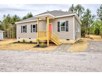 Charming single-story home featuring a welcoming front porch and neutral siding with black shutters at 48 S Grace Way, Henderson, NC 27537
