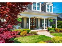 Charming home featuring a cozy front porch with decorative wreaths and lush landscaping at 658 Bennett Mountain Trce, Chapel Hill, NC 27516
