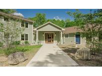 Lovely exterior home view showcasing a charming walkway, sage green siding, and a welcoming entrance at 7955 Midnight Ln, Wake Forest, NC 27587
