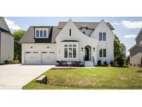 Beautiful two-story home with a well-manicured lawn, attached two car garage, and classic black and white trim at 928 Lily Claire Ln, Fuquay Varina, NC 27526