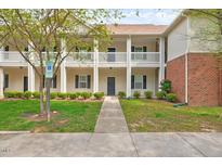 Charming two-story condo with classic architecture, beautiful landscaping and inviting walkway to the main entrance at 1123 Claret Ln, Morrisville, NC 27560