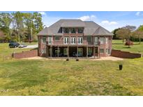 Spacious brick home featuring a large deck ideal for outdoor entertaining with an expansive lawn at 1174 Robertson Rd, Roxboro, NC 27574