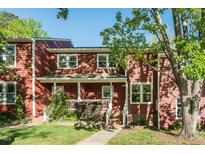 Charming two-story townhouse with red siding, white trim, and a well-maintained front yard at 127 Long Shadow Pl, Durham, NC 27713