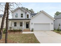 Charming two-story home with a welcoming front porch and attached two-car garage at 157 Maplewood Dr, Sanford, NC 27332