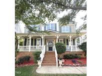 Charming two-story home featuring a welcoming front porch with white railing and brick accents at 161 Fort Jackson Rd, Morrisville, NC 27560