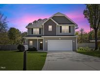 Charming two-story home with a well-manicured lawn and a two-car garage at 166 Old Field Loop Loop, Sanford, NC 27332