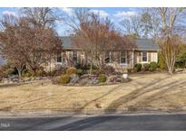 Charming single-story home with neutral siding, well-kept landscaping, and mature trees at 2009 Mallard Ln, Raleigh, NC 27609