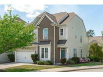 Inviting two-story home featuring brick and siding accents, a well-manicured lawn, and a charming front yard at 2227 Rocky Bay Ct, Cary, NC 27519