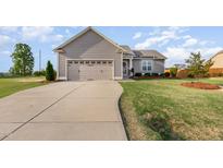 Charming single-Gathering home featuring a well-manicured lawn and attached two-car garage at 25 Cornfield Ln, Benson, NC 27504