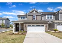Inviting two-story home with brick accents, a two-car garage, and well-maintained landscaping at 2528 Forge Village Way, Apex, NC 27523