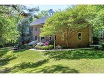 Beautiful two-story brick home with mature landscaping and inviting backyard at 2901 Hunters Bluff Dr, Raleigh, NC 27606