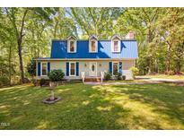 Charming two-story home with blue shutters, a matching roof, and a well-manicured lawn at 3312 Shannon Cir, Apex, NC 27539