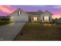 Charming single-Gathering home featuring a well-manicured lawn and attached two-car garage at 367 Fenella Dr, Four Oaks, NC 27524