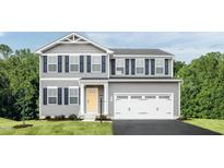 Charming two-story home features a two-car garage, yellow front door, and black shutters at 368 N Coral Bells Way, Four Oaks, NC 27524