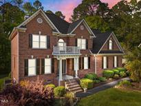 Stunning brick two-story home with black shutters and manicured landscaping at 5016 Dillswood Ln, Raleigh, NC 27606