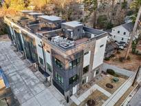 Modern townhome boasts a rooftop deck with outdoor seating and city views at 516 Edgecreek Ct, Raleigh, NC 27604