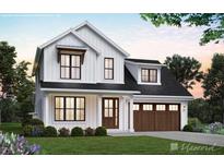 Charming two-story modern farmhouse with a black roof, a well-manicured lawn, and a two car garage at 5491 Silk Hope Gum Springs Rd, Siler City, NC 27344
