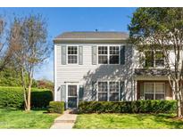 Inviting two-story townhome with green shutters and landscaped front yard, perfect for low-maintenance living at 614 Canyon Lake Cir, Morrisville, NC 27560
