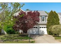 Charming two-story home featuring a well-manicured lawn and a two-car garage at 712 Wellspring Dr, Holly Springs, NC 27540