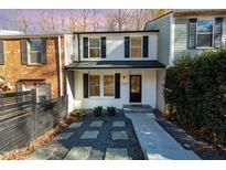 Charming two-story home with black shutters, manicured shrubs, and walkway to front door at 7324 Summerland Dr, Raleigh, NC 27612