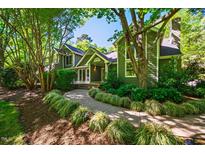 Charming home with lush landscaping and a welcoming walkway leading to the front door at 102 Antler Point Rd, Chapel Hill, NC 27516
