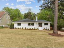 Charming, renovated brick ranch home featuring a beautifully landscaped front yard and inviting entryway at 1310 Mayfair Rd, Raleigh, NC 27608