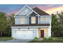Charming two-story home featuring a two-car garage, light gray siding, and a welcoming front entrance at 1311 Hollyview Ave, Durham, NC 27703
