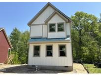 New two-story home featuring light-colored siding, gray trim, and black windows ready for customization at 1448A Maplewood Dr, Durham, NC 27704