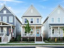 Charming two-story home features a welcoming front porch and light gray siding at 1517 Millrock Trl, Wendell, NC 27591