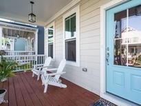 Inviting front porch with Adirondack chairs and baby blue front door at 1517 Millrock Trl, Wendell, NC 27591