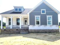 Charming two-story new home with a covered porch and modern gray siding at 152 Cultivator Ct, Angier, NC 27501