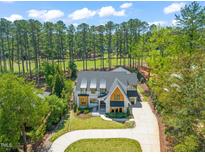 Stunning home boasts a spacious circular driveway, lush lawn, and beautiful landscaping at 1616 Hunting Ridge Rd, Raleigh, NC 27615