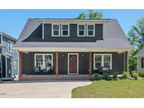 Charming two-story home features a covered front porch, beautiful windows, and well-maintained landscaping at 2019 James St, Durham, NC 27707