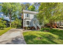 Charming two-story home with a bay window and a well-manicured lawn at 3109 E Folkestone Pl, Raleigh, NC 27604