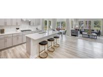 Bright, open kitchen featuring an island with bar seating and stainless steel appliances at 3813 Rosebush Dr, Zebulon, NC 27597