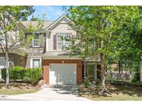 Charming two-story home boasts brick and siding, plus a one-car garage and inviting front entrance at 4240 Camden Woods Ct, Raleigh, NC 27612