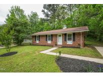 Charming single-story brick home with a well-maintained front yard and inviting walkway at 508 Solar Dr, Raleigh, NC 27610