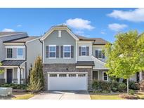 Charming two-story home with a stone accent, neutral colors and a two car garage at 512 Flip Trl, Cary, NC 27513