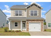 Charming two-story home featuring a one-car garage and a welcoming front porch at 632 Hunters Ridge Dr, Fuquay Varina, NC 27526