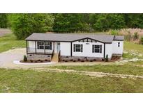 Charming single-story home featuring classic white siding, decorative shutters and a covered front porch at 66 Privette Way, Zebulon, NC 27597