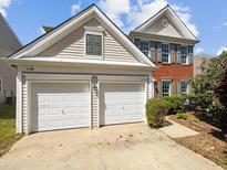 Charming home featuring a two-car garage and a blend of brick and siding exterior at 7425 Silver View Ln, Raleigh, NC 27613