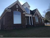 Beautiful brick home with large windows and manicured lawn at 84 Dogeye Rd, Benson, NC 27504