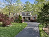 Charming home featuring a landscaped yard and stone accents at 85 Rivers Edge Ct, Timberlake, NC 27583
