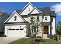 Charming two-story home featuring a two-car garage and a blend of siding and brick accents at 108 Clements Dr, Morrisville, NC 27560
