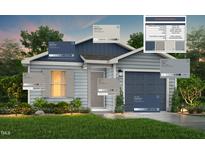 Charming home exterior featuring complementary blue and grey colors, coordinated shutters, and a well-manicured lawn at 123 Landon Pl, Roxboro, NC 27573